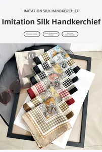 Detailed view of floral silk-like square scarf styled with sunglasses and lifestyle props