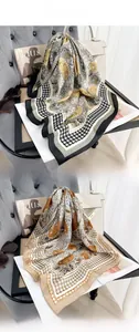 Detail of vintage floral and houndstooth print silk scarves styled with high-end bags