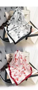 Detail of silk-texture square scarf with ginkgo leaf print and contrasting edges
