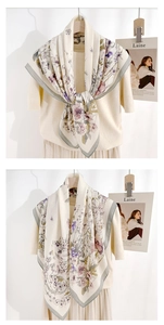 Floral silk scarf with pink and purple blossoms and grey contrast border on a beige top