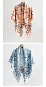 Detailed close-up of equestrian chain print and floral textures on thin silk scarf
