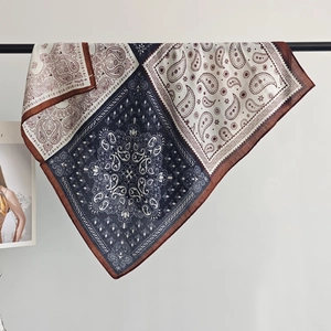 Close-up of navy and beige paisley pattern cotton-linen scarf on a black metal rod