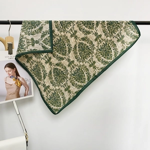Detail of vintage floral silk scarf featuring baroque patterns and deep green hem