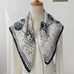 Astrology print black and white silk scarf styled with a white shirt for women