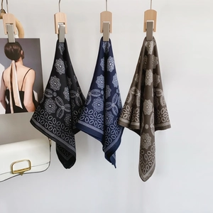 Hanging geometric print square scarves in navy, black and brown colors with floral pattern
