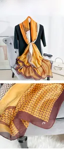 Detail of elegant houndstooth geometric silk scarf featuring ginger and beige patchwork