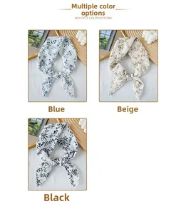 Detail view of floral print scarves in blue, beige and black with scalloped edges
