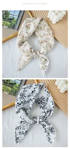 Detailed view of floral silk scarves with lace edges tied in elegant bow knots