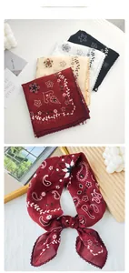 Detail of vintage paisley scarves in various colors with delicate lace edges and sheer texture