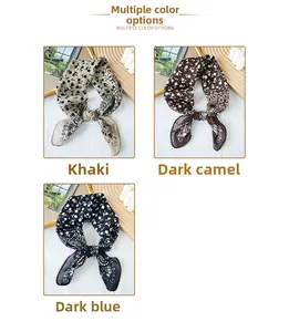 Detailed view of paisley silk scarves in khaki, dark camel and navy blue colors