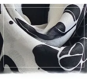 Macro detail of mercerized wool scarf fabric with black and white artistic floral leaf print