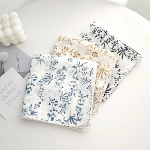Three-piece set of floral square scarves with crochet lace edges in blue, brown, and black