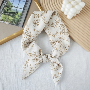 Elegant floral square scarf with wavy edges and brown leaf patterns in minimalist setup