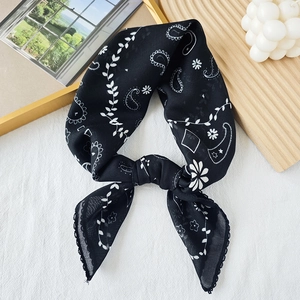 Elegant black paisley bandana scarf with white floral print on a textured background
