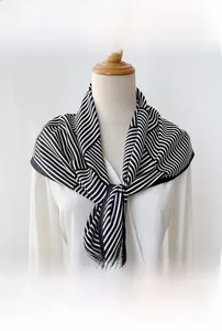 Detail shot of a minimalist black and white striped satin triangle scarf for styling