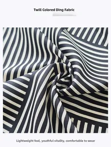 Detail of minimalist black and white striped twill satin fabric with a silky glossy finish