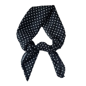Classic black and white polka dot linen cotton scarf tied in a stylish knot