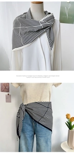 Styling detail of a black and white striped triangle neck scarf with a velvet texture feel
