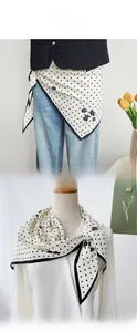Close-up of elegant polka dot silk scarf worn as a stylish waist belt and neckerchief