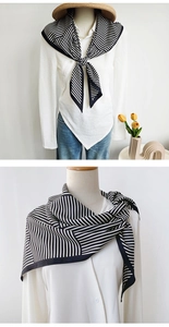 Detail of a minimalist black and white striped silk scarf showing fine texture and drapes