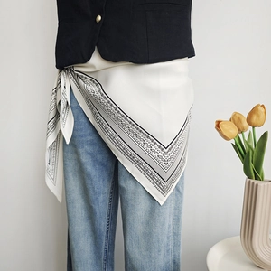 Cream satin triangular scarf with black paisley pattern used as a creative waist accessory