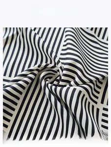 Macro detail of breathable black and white twill satin fabric with geometric stripe print