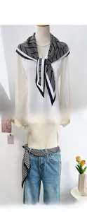 Detail view of black and white striped silk scarf used as necktie and belt accessory