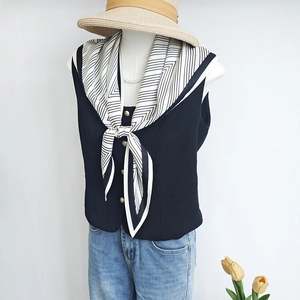 Navy sleeveless waistcoat with black and white geometric pattern neck scarf silk accessory