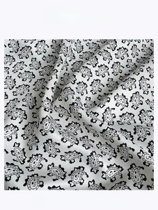 Detailed close-up of twill satin fabric showing cartoon pattern and smooth texture
