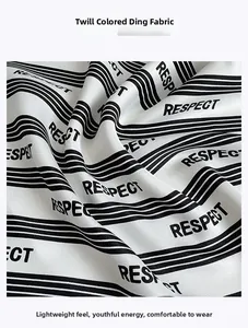 Macro detail of silk-like satin fabric with classic black and white stripes and lettering