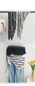 Detail of luxury triangle scarf featuring black and white stripes with Respect lettering