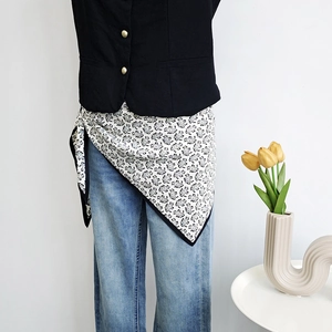 Black and white paisley print satin silk scarf styled as an elegant waist accessory