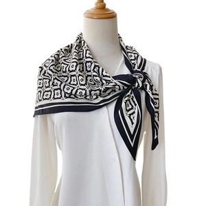 Floral print geometric silk neckerchief styled on a white shirt in a professional look