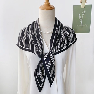 Elegant black and white striped silk scarf with RESPECT print on fashion mannequin