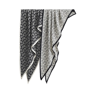Elegant paisley print triangle silk scarf in classic black and white floral patterns