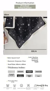 Detail of black and white polka dot silk square scarf showing fabric specs and texture