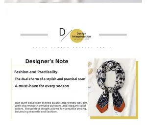 Detailed view of navy paisley silk scarf with orange borders and brand tag