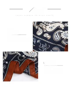 Close-up of navy paisley pattern fabric with fine texture and rolled hem edge