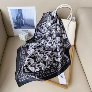 Classic black and white paisley satin silk scarf styled with a white leather handbag