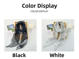 Polka dot chiffon scarves displayed in black and white side by side on a textured fabric