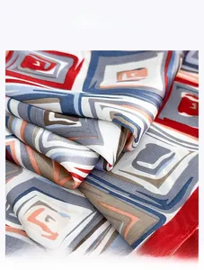 Close-up of geometric pattern silk-like scarf showing texture and vibrant colors
