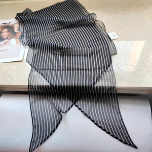 Macro shot of 100% silk black and white striped scarf with refined pointed ends