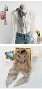 Detailed close-up of chiffon checkerboard scarves styled on a white shirt and in a gold tray