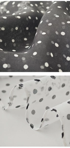 Close-up of polka dot chiffon fabric with lightweight mesh texture in black and white