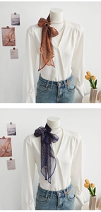 Dettaglio di un elegante nastro di chiffon annodato a fiocco sul colletto di una camicia