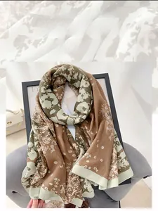 Detailed texture of cotton linen scarf with vintage floral and abstract prints in camel color