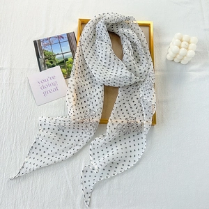 Elegant white chiffon scarf with black polka dots and floral print on a frame