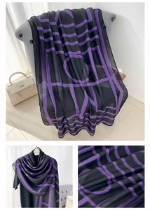Detail view of cotton linen scarf with purple geometric letters and soft texture