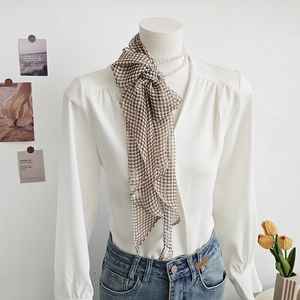 Elegant chiffon necktie scarf with brown checkerboard pattern styled on white shirt