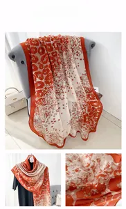 Close-up of lightweight linen leopard print scarf with vibrant orange wide borders